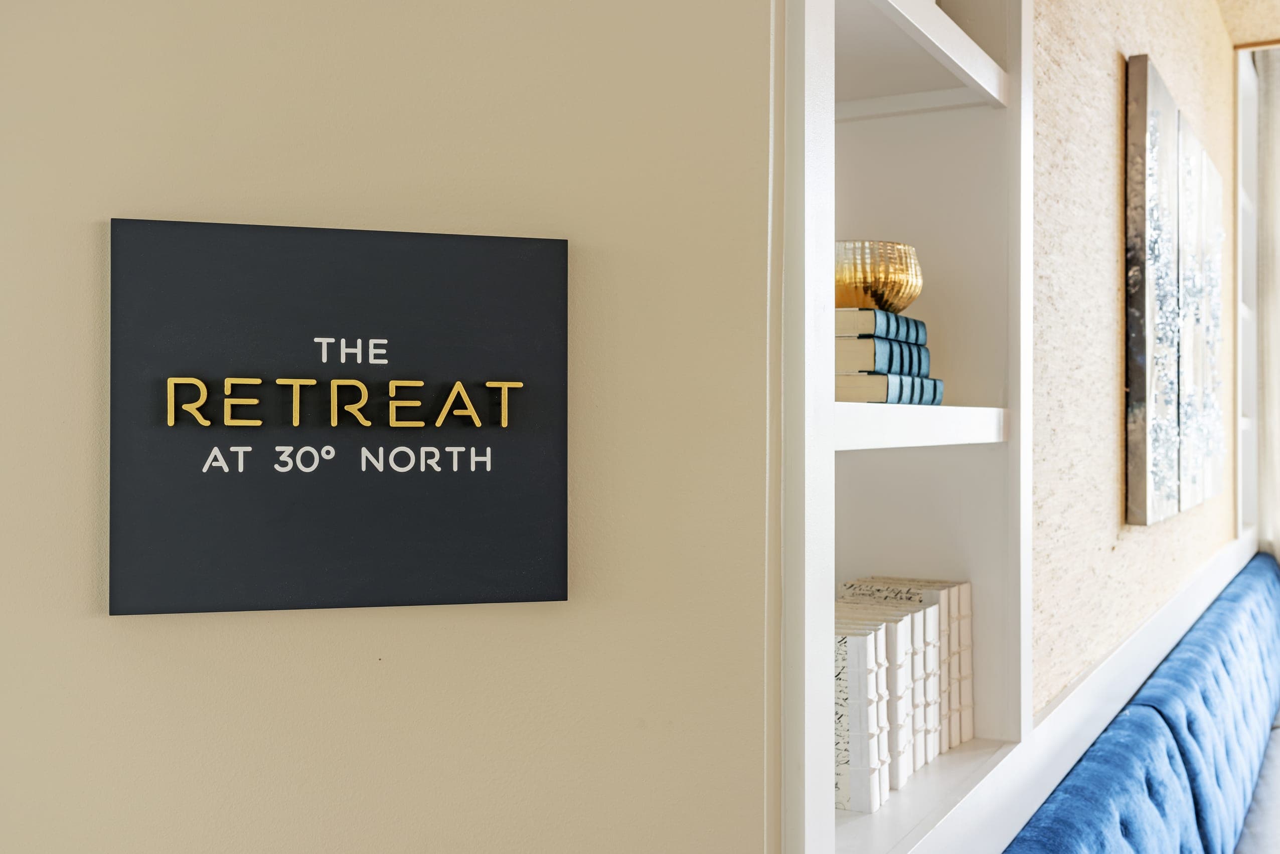 Retreat Sign Gold Lettering Recessed Book Case Blue Satin Booth Seat