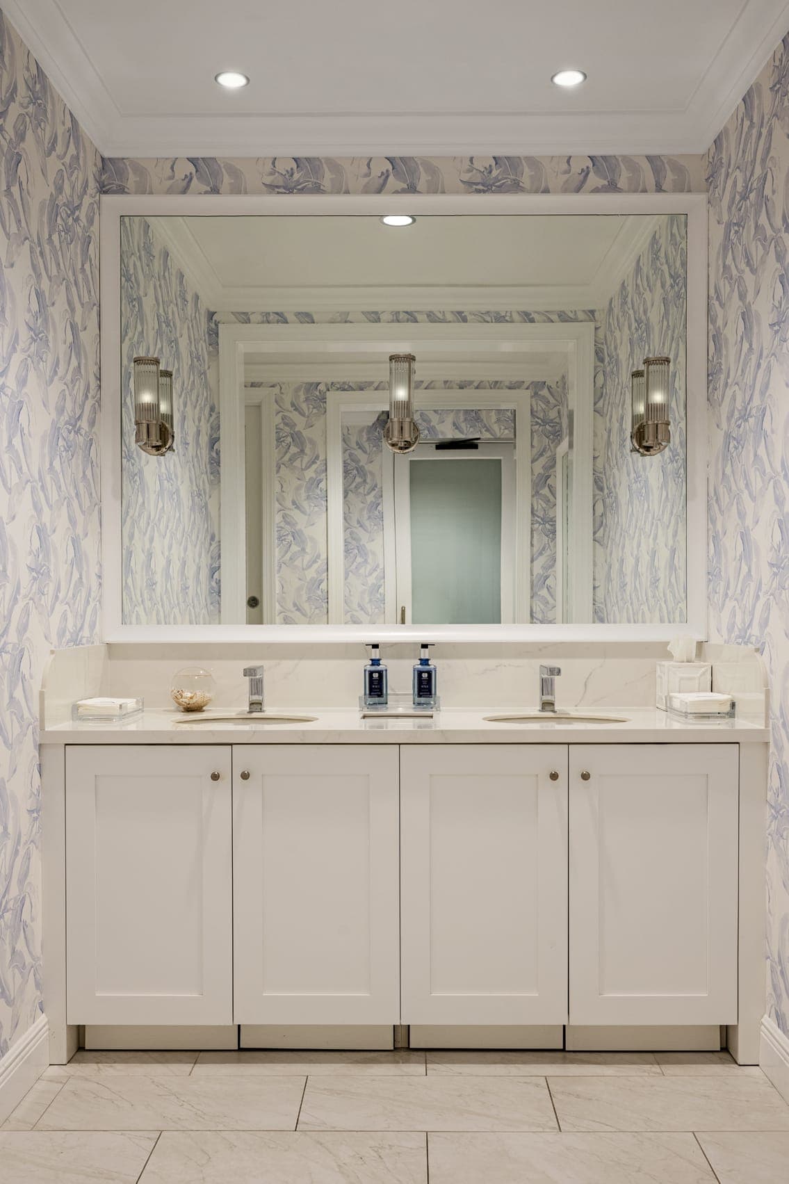 Bathroom Dual Sink Area White Cabinets Blue Leaf Pattern Wall Paper