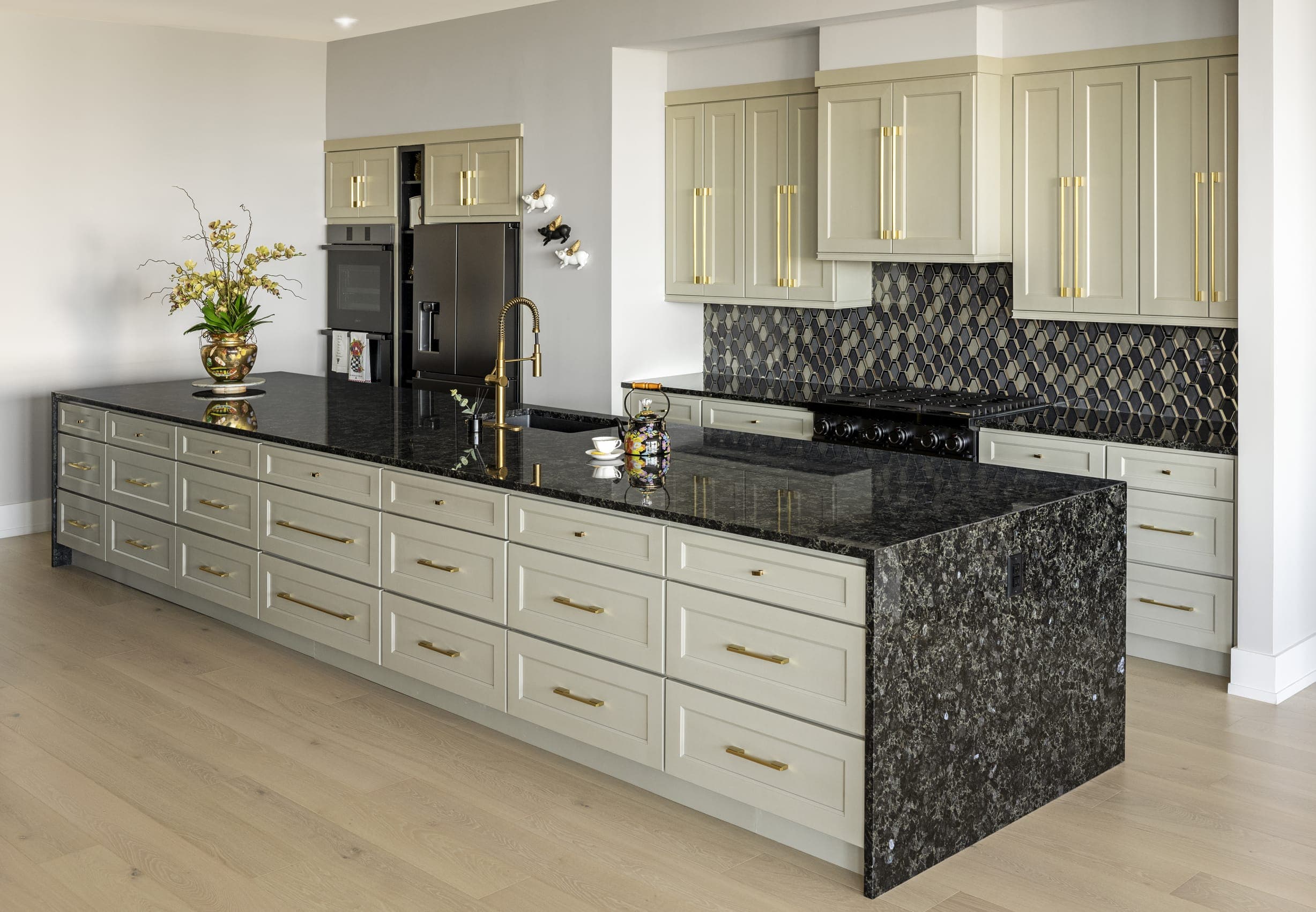 Black Stone Kitchen Island Dark Herringbone Tile Back Splash Gold Handled Olive Grey Cabinets Grey Painted Walls