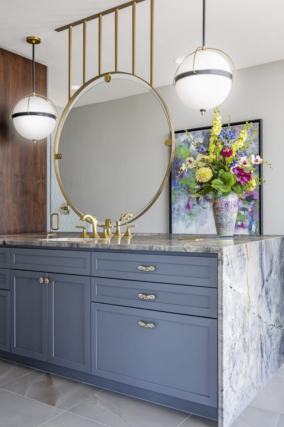 Master Bathroom Wash Sink Area Gold Circular Framed Mirror Dark Blue Cabinets Orbe Light Fixtures Three Quater View