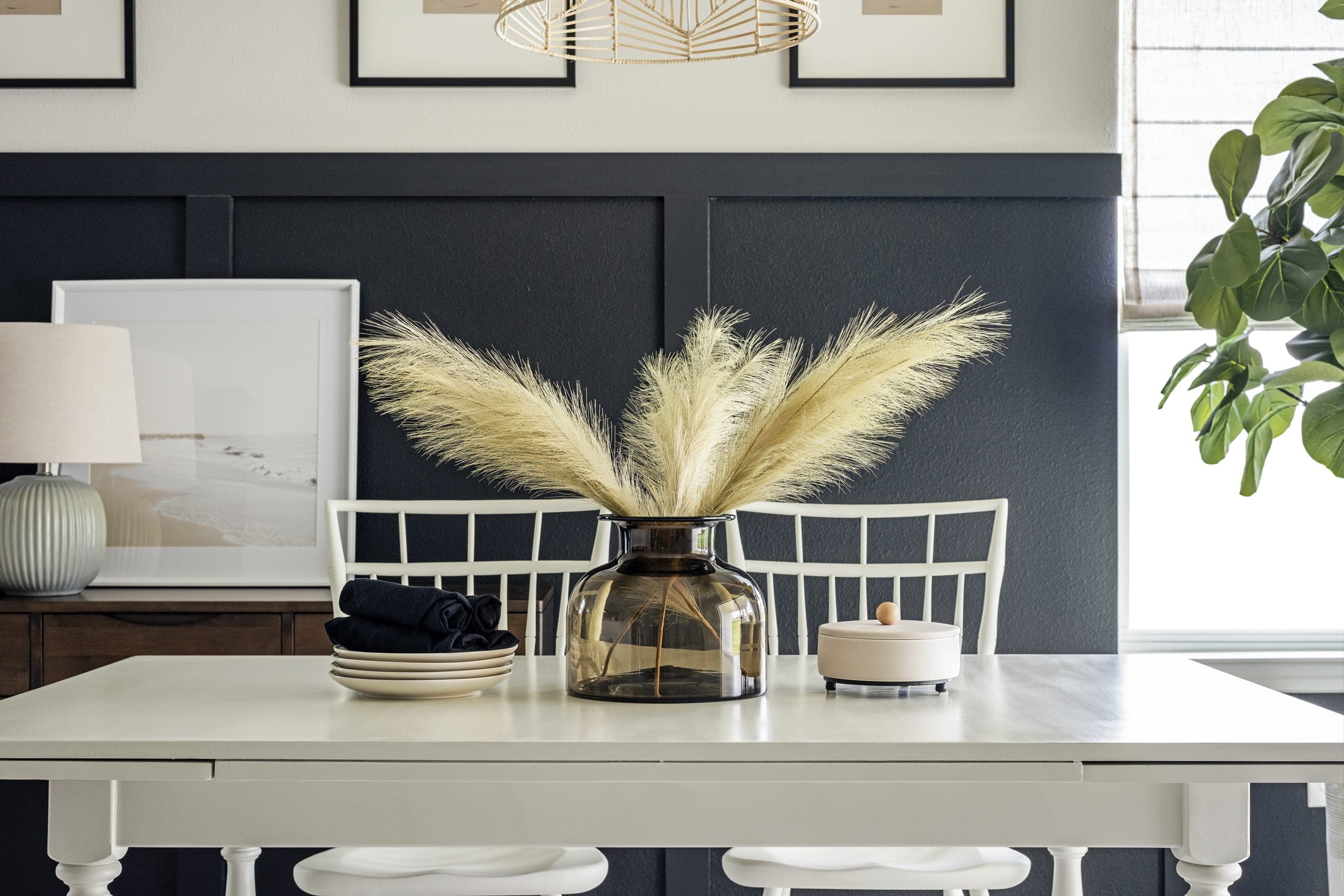 White Dining Table Feathers In Dark Glass Vase Dark Blue Wainscoting