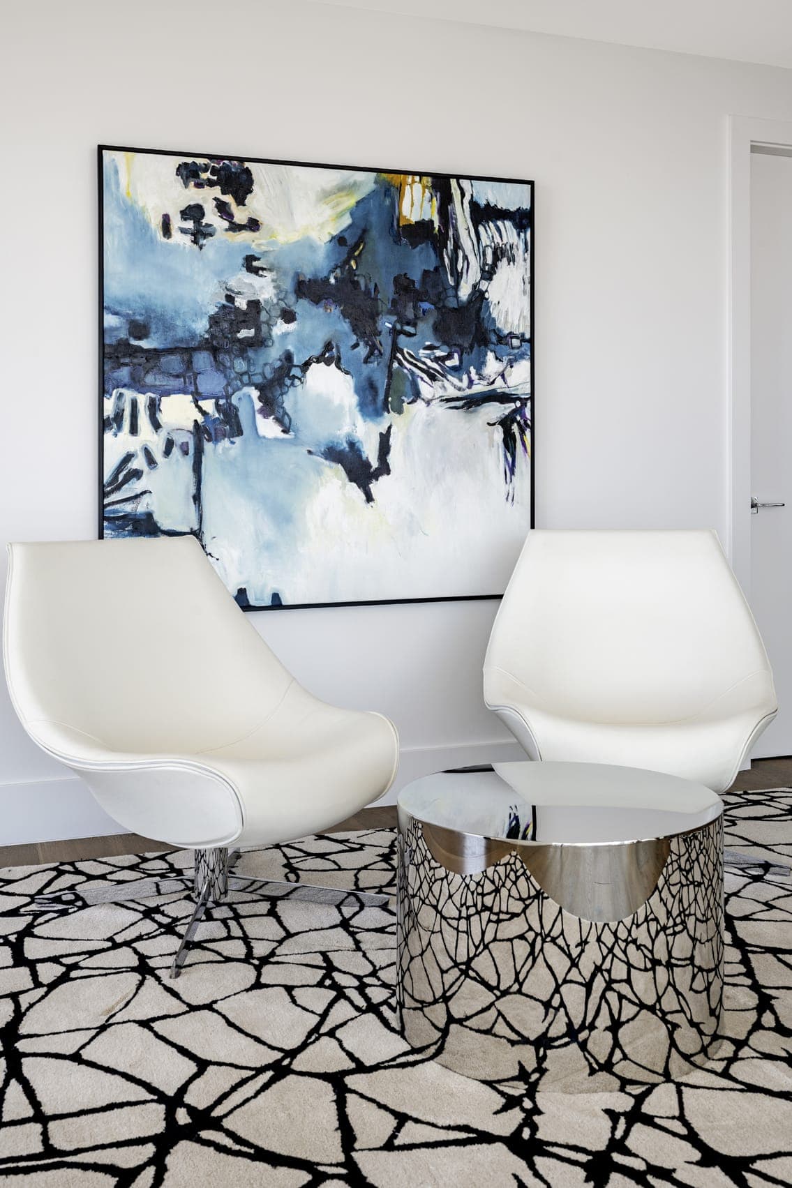Jkl Penthouse The Blvd Contemporary White Leather Armchairs Metalic Coffee Table Impressionistic Artwork