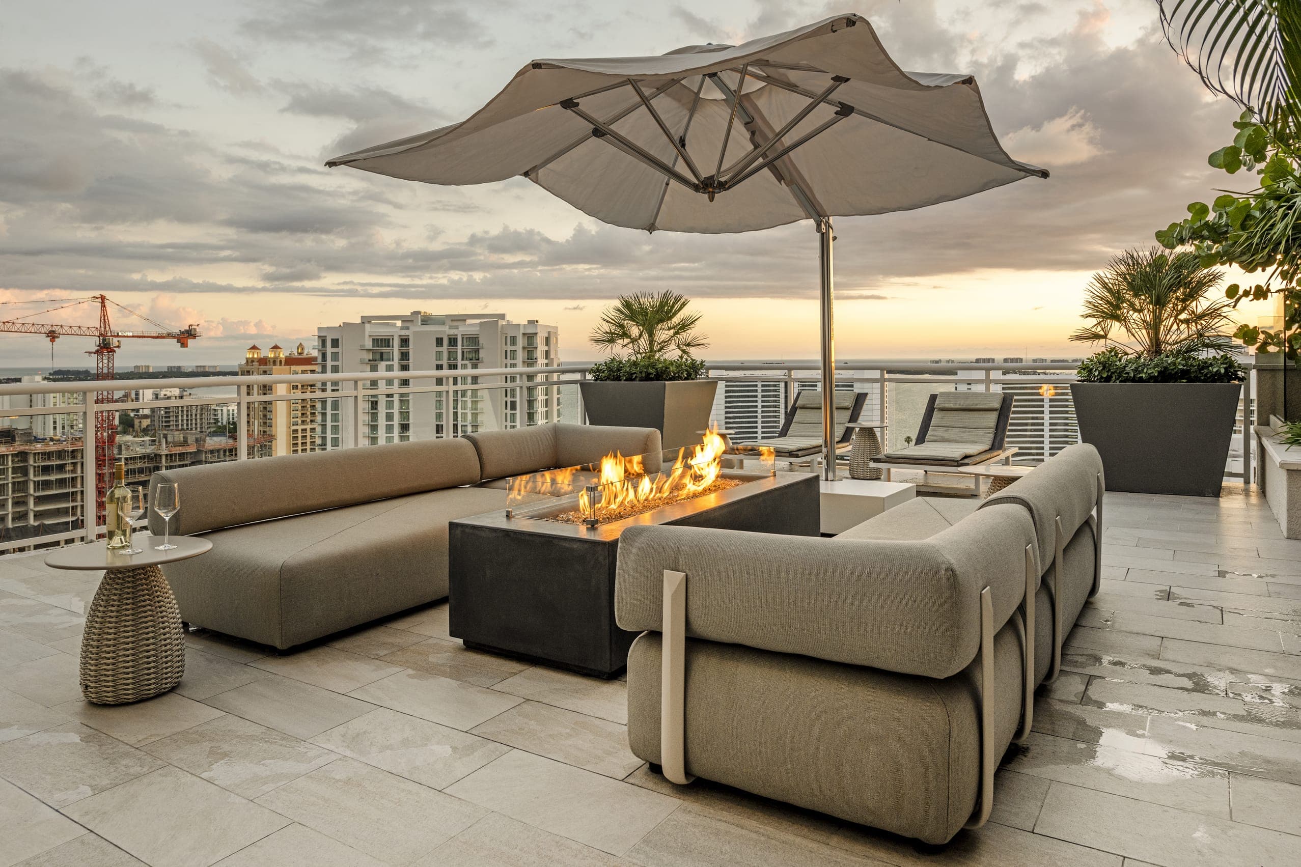 Jkl Penthouse The Blvd Outdoor Sitting Area At Sunset Fire Pit Grey Outdoor Couch
